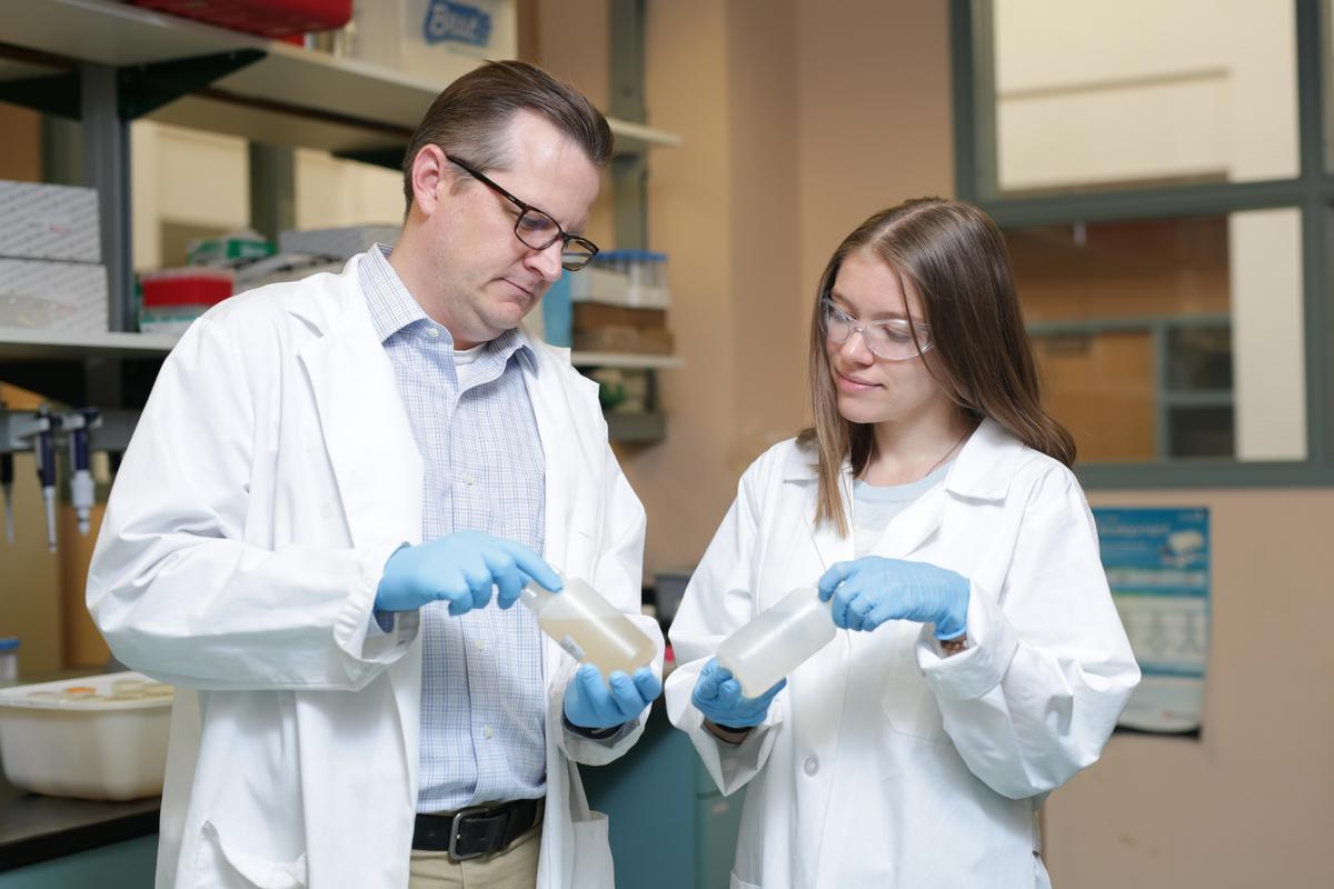 Professor and student working on research at Mines