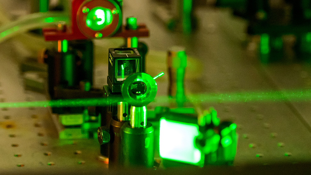 A green laser is being used on a machine.