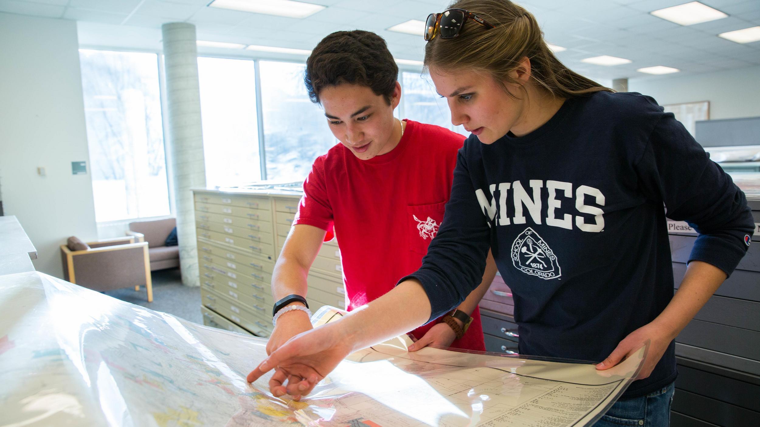 two students looking at a map.