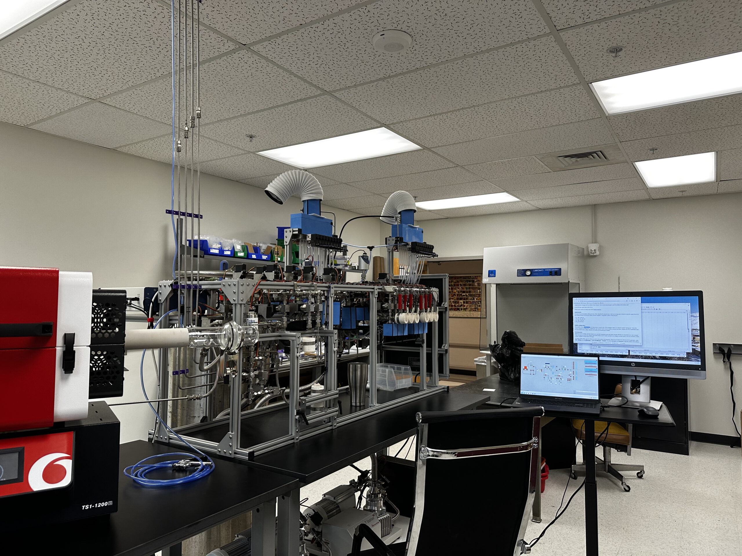 A laboratory with a computer and a monitor on a desk.