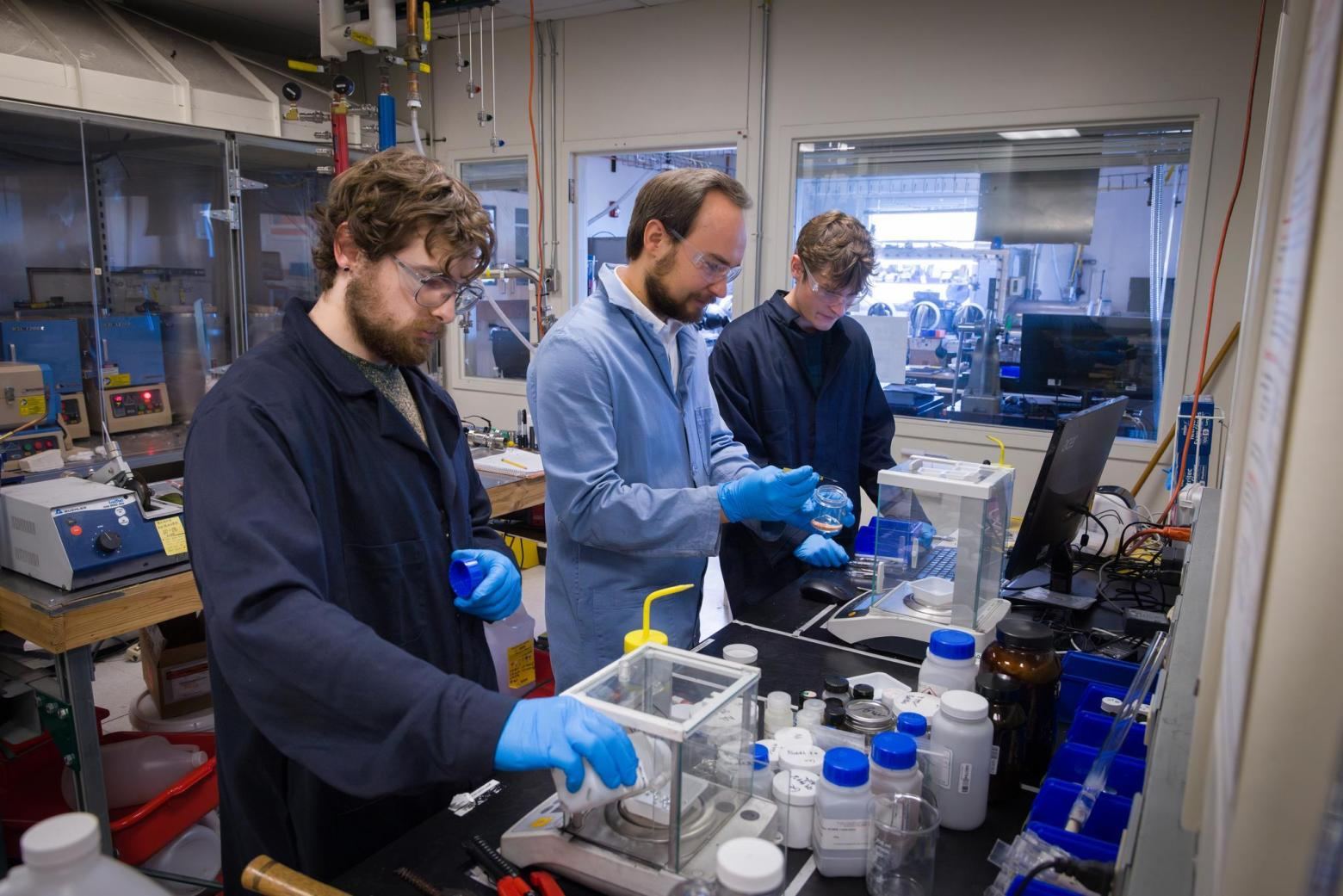 A group of men working in a laboratory.